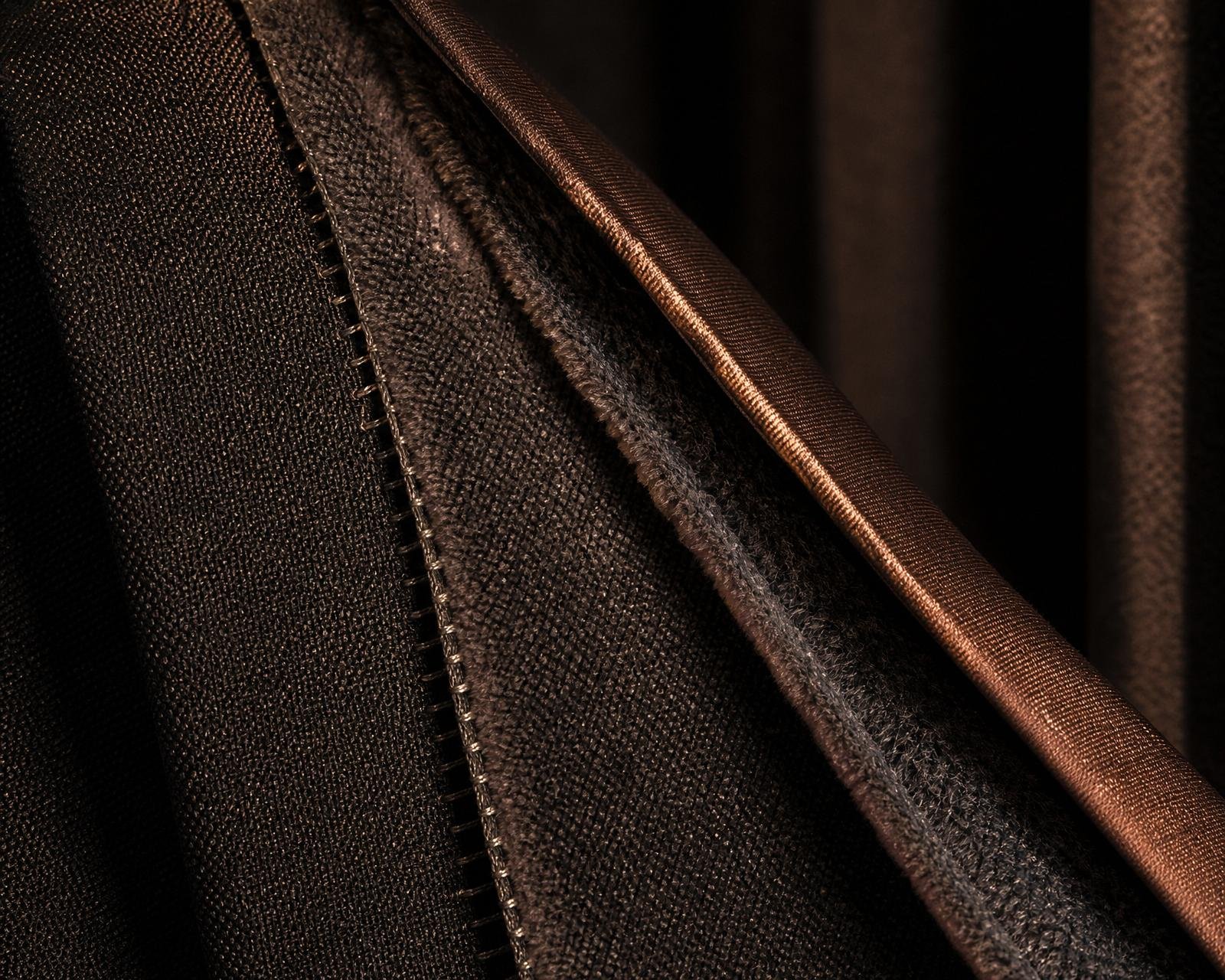 Macro detail of acoustic interlining and stitching on a heavy blackout curtain