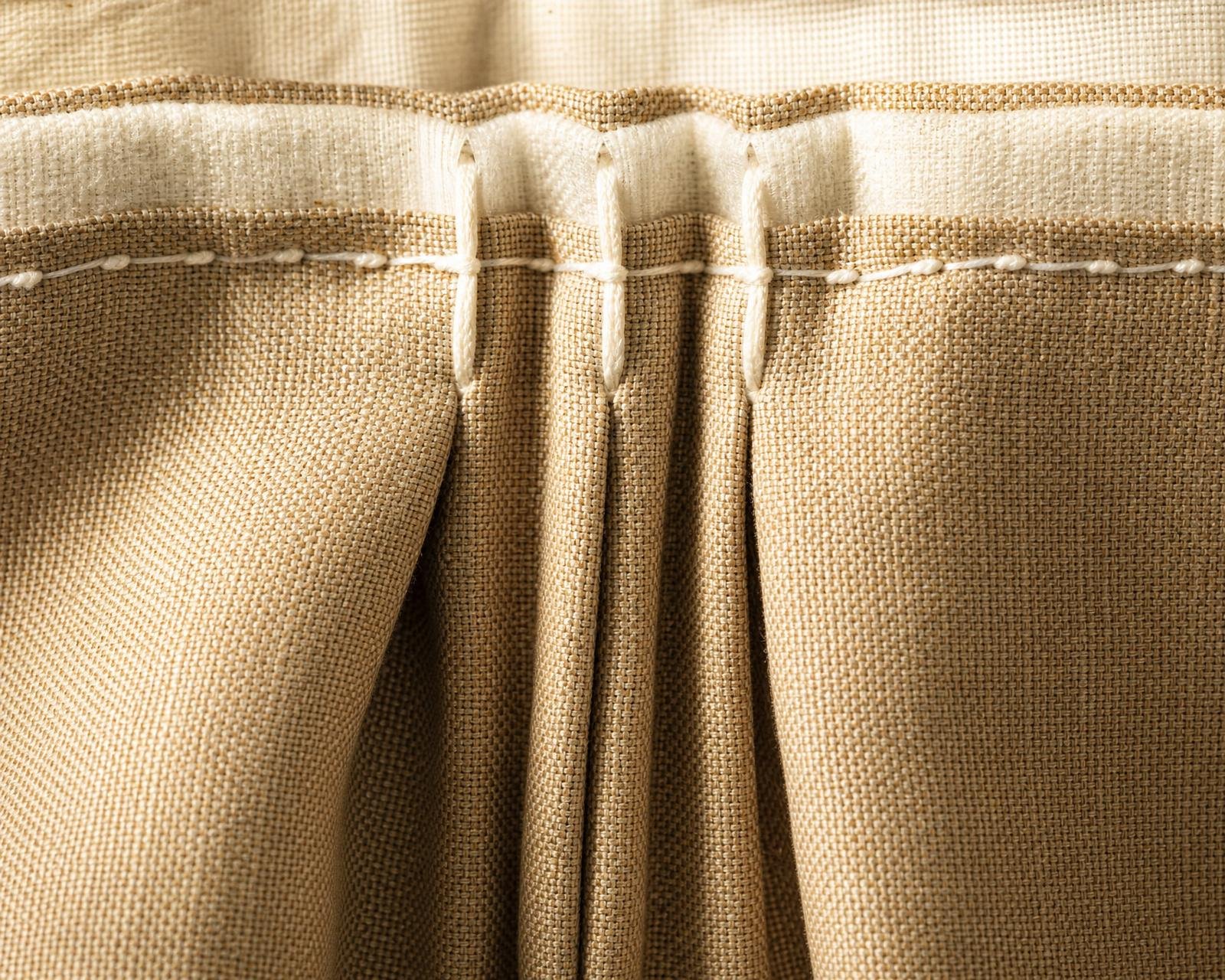 Macro detail of a hand-stitched triple pinch pleat curtain header