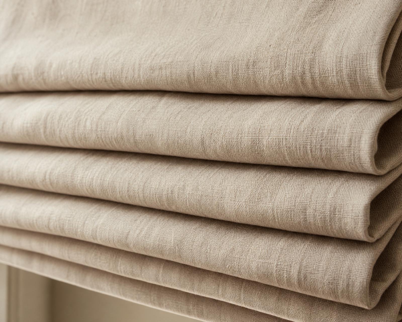 Close-up of stacked soft horizontal folds of a raised Roman shade