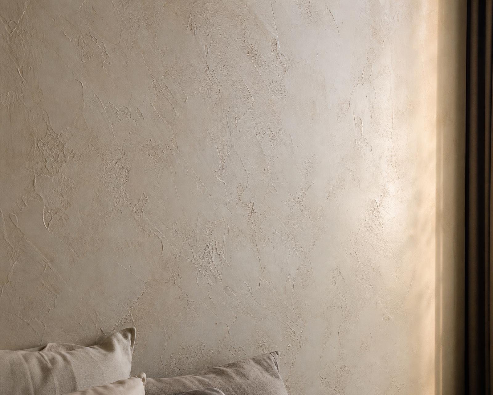 Sculpted plaster-effect textured wallpaper in warm bone-white in a Dubai master bedroom